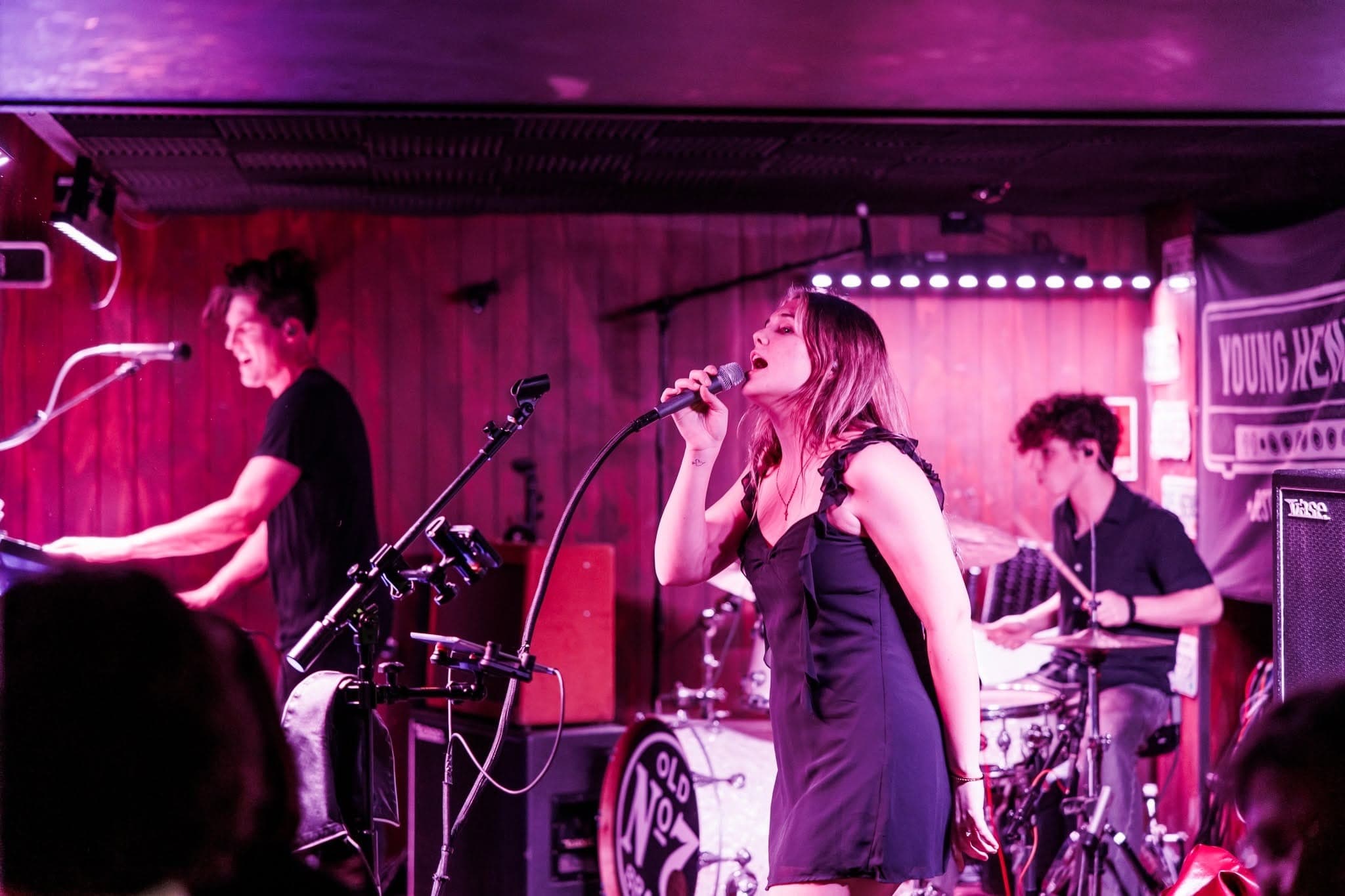 Singer under pink stage lights
