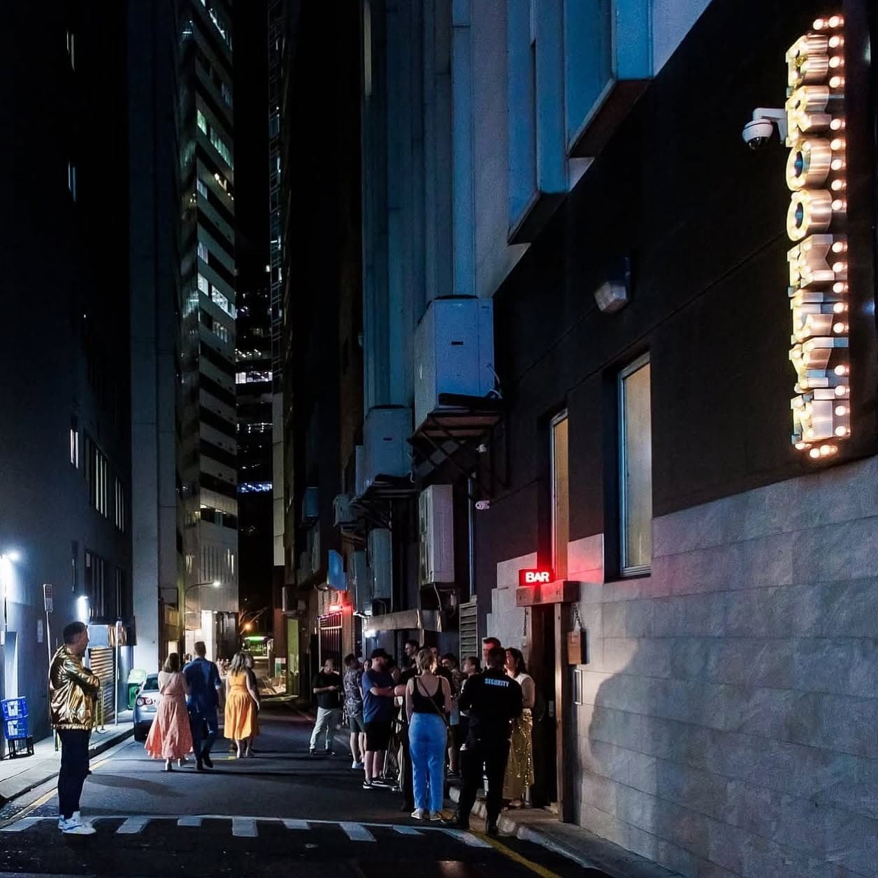 Eagle Lane at night with the Brooklyn Standard sign lit up